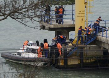 Russian rescue workers carry a body from the wreckage of the crashed plane, at a pier just outside Sochi, Russia, Sunday, Dec. 25, 2016. Russian ships, helicopters and drones are searching for bodies after a plane carrying 92 people crashed into the Black Sea. The plane was taking the Alexandrov Ensemble,...  (Associated Press)