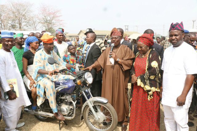 sumonu 5 - National Insight News Executive Governor of Oyo state Sen Ajimobi presenting Motorcyc;le to  a beneficiaies while Sen Sumonu and  Hon Akeem Adeyemi watches.