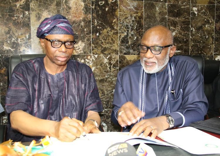 SAM-4 - National Insight News Outgoing Governor of Ondo State, Dr Olusegun Mimiko (left) and the
Incoming Governor, Rotimi Akeredolu (SAN), signing the handover notes