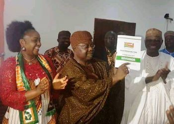 Senator Omisore displaying the form