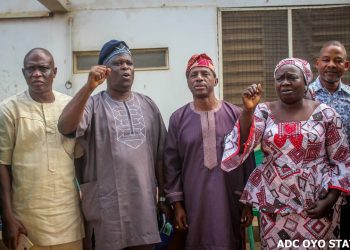 Comrade Abdulwaheed Olojede, Oyo State NLC Chairman, leading solidarity songs, in a group photograph with Senator Olufemi Lanlehin. With them is Arch Basiru Lawal, DG, Handshake Campaign Organisation (HCO), and another union official