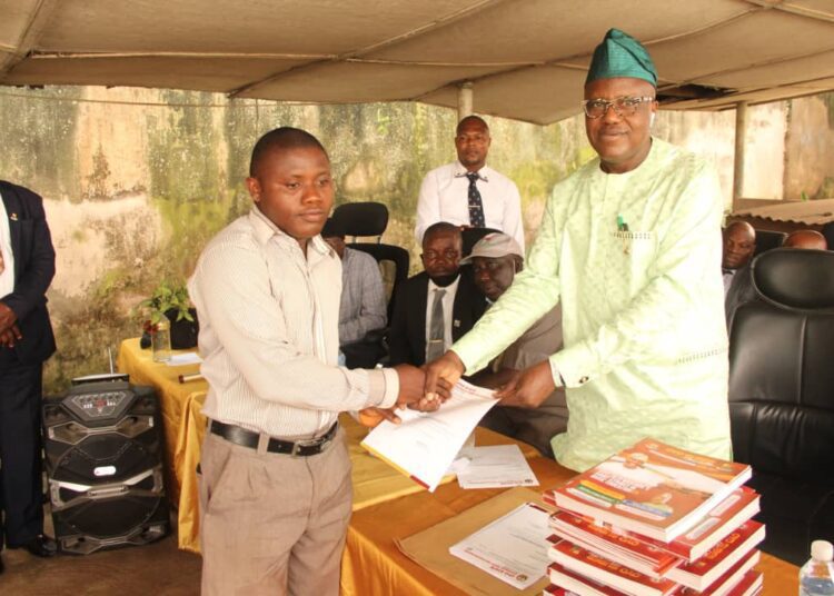 Dr_ Adeniran presenting letter to a teacher - National Insight News