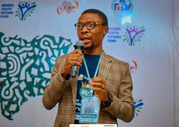 Rep of Kano state Governor Abba Gida presenting food items to one of the beneficiaries