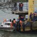 Russian rescue workers carry a body from the wreckage of the crashed plane, at a pier just outside Sochi, Russia, Sunday, Dec. 25, 2016. Russian ships, helicopters and drones are searching for bodies after a plane carrying 92 people crashed into the Black Sea. The plane was taking the Alexandrov Ensemble,...  (Associated Press)