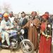 Executive Governor of Oyo state Sen Ajimobi presenting Motorcyc;le to  a beneficiaies while Sen Sumonu and  Hon Akeem Adeyemi watches.