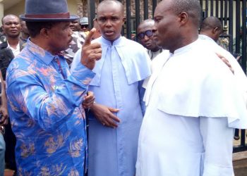 Governor Obiano being briefed by the priest of the church where worshippers were killed in Anambra yesterday.