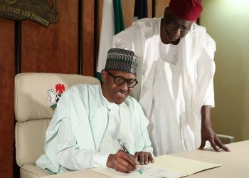 President Buhari signing a letter