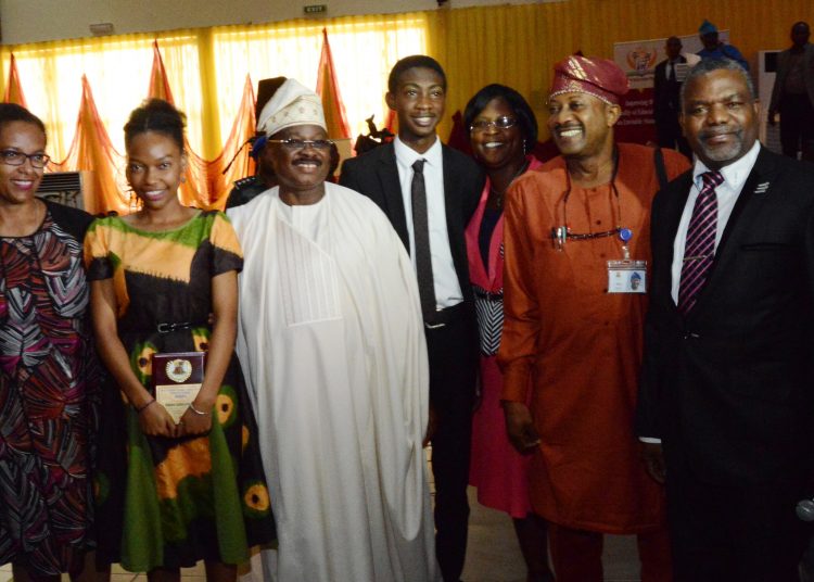Governor Abiola Ajimobi of Oyo State (third left) with the best 2017 WASSCE female best student, Miss Irabor Isabele Gelegu (second left), her mum, Mrs Elizabeth Irabor (left), the best 2017 male student, Master Oluwatoni Adekunle (middle) his father and mother, Professor and Mrs Segun Adekunle and a senior pastor at Oritamefa Baptist Church, Rev. Dr Remi Awopegba at the launch of Oyo Education Trust Fund where the two students were honoured by the Oyo State Government.