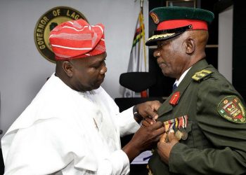 Governor Akinwumi Ambode decorating  the Chairman of the Nigerian Legion, Lagos State Council, retired Col. Fola Akande