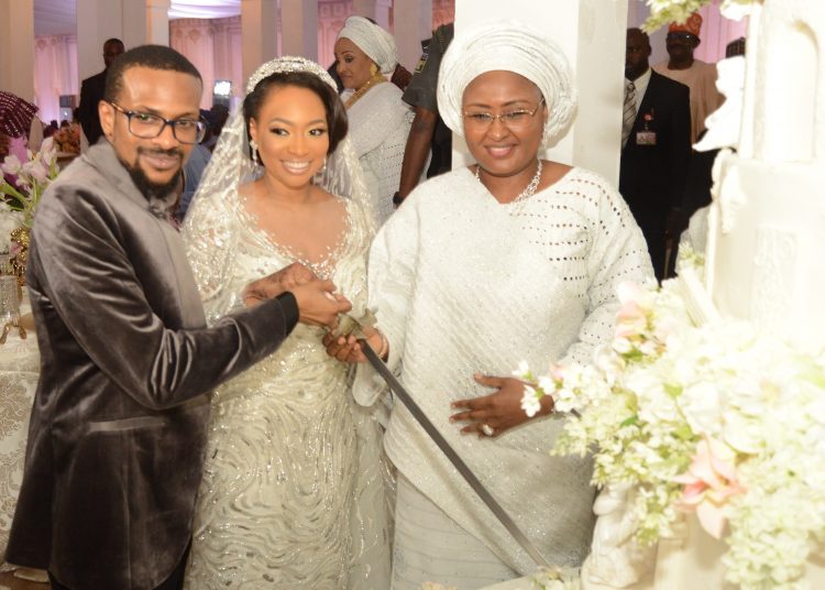 Wife of the President, Hajia Aishat Buhari  with the couple cutting the cake