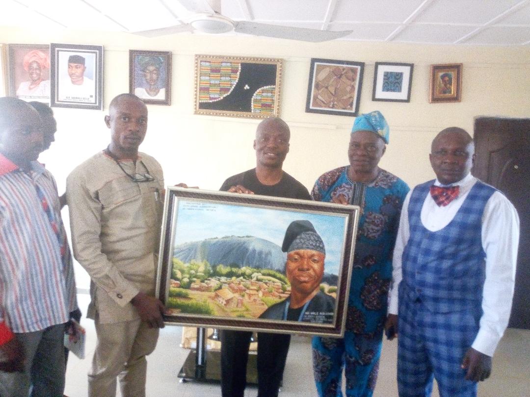 Comrade Jacob Ayodele and some of the Association presenting Artwork to the Amb, Wale Ojo Lanre Director General Council for Arts and Culture, Ekiti state
