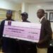 Picture shows the Oyo State Commissioner for Youths and Sports, Asiwaju Seun Fakorede, the World Boxing Federation's International Super Featherweight Winner, Ridwan Oyekola 'Scorpion' and the Permanent Secretary of the Ministry, Mr Oludele Oyadeyi as the Commissioner presents the Ten Million naira cheque to the boxer