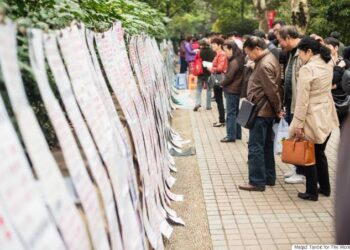 Parents looking at advertisement | Image: MatjazTancic for The WorldPost