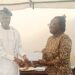 Prof.Duro Oni, president of The Ijesa Society,presenting of the Awards to Miss Ademosoye Precious, a 200level student of Mass Communication, UNILAG.