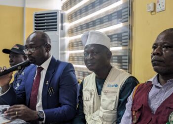 Dr. Olatunji (with mic), speaking during the Press conference today.