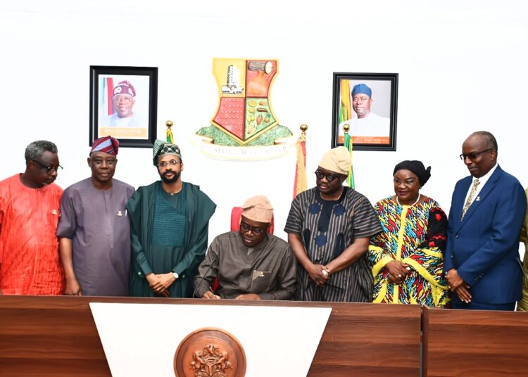 Oyo State Governor, Seyi Makinde (middle); signing the bill to rename The First Technical University, Ibadan as Abiola Ajimobi Technical University, Ibadan to law, with him from left are, the University Vice Chancellor, Prof Sola Ajayi; Pro-Chancellor, Ladoke Akintola University of Technology, Prof Deji Omole; deputy governor of Oyo State, Barr Bayo Lawal; son of former governor of Oyo State, Mr Idris Ajimobi; deputy Speaker of Oyo State House of Assembly, Hon Biodun Fadeyi; Senator Mosurat Sunmonu; representative of Chief Judge of Oyo State, Justice A L Akintola and Commissioner for Education, Prof Saliu Adelabu, held at Executive Chamber, Governor's Office, Secretariat, Ibadan. PHOTO: Oyo Gov's Media