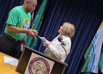 Damien Unogu (left) President, Nigerian American Association of the Inland Northwest (NAAINW) receiving a copy of the Proclamation of Nigerian American week from the Mayor of Spokane, Washington State, Lisa Brown.