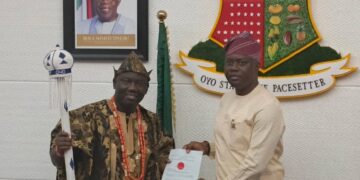 Governor Seyi Makinde presenting instrument of office to prince Akeem Abimbola Owoade, the new Alaafin of Oyo