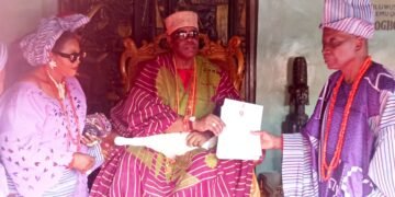 Oba Ghandi Afolabi Olaoye presenting certificate to Dr Saka Balogun as the new Balogun of Ogbomosoland