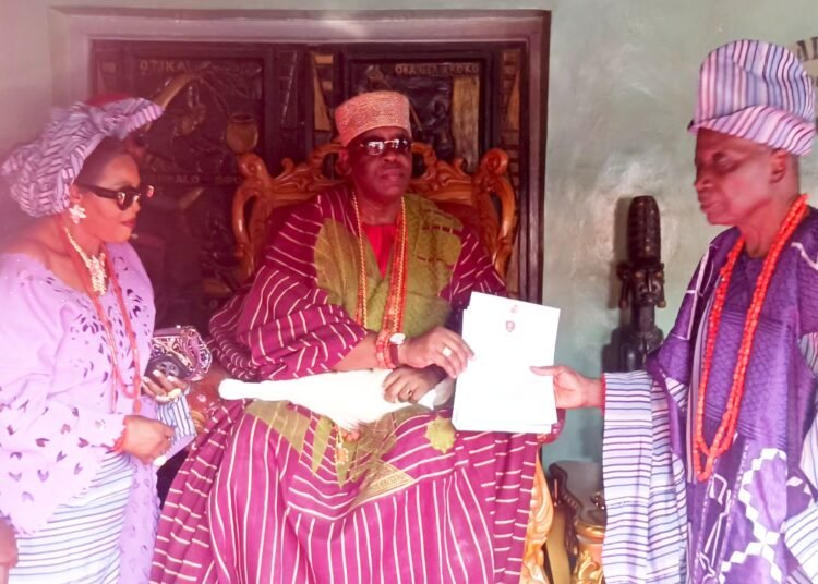 Oba Ghandi Afolabi Olaoye presenting certificate to Dr Saka Balogun as the new Balogun of Ogbomosoland
