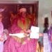 Oba Ghandi Afolabi Olaoye presenting certificate to Dr Saka Balogun as the new Balogun of Ogbomosoland